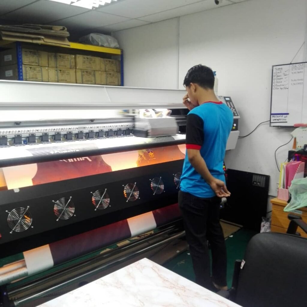 Operator mengendalikan mesin cetak sublimation Saudagar Printing Malaysia